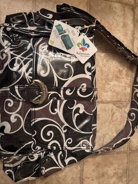 Laminated buckle diaper bag